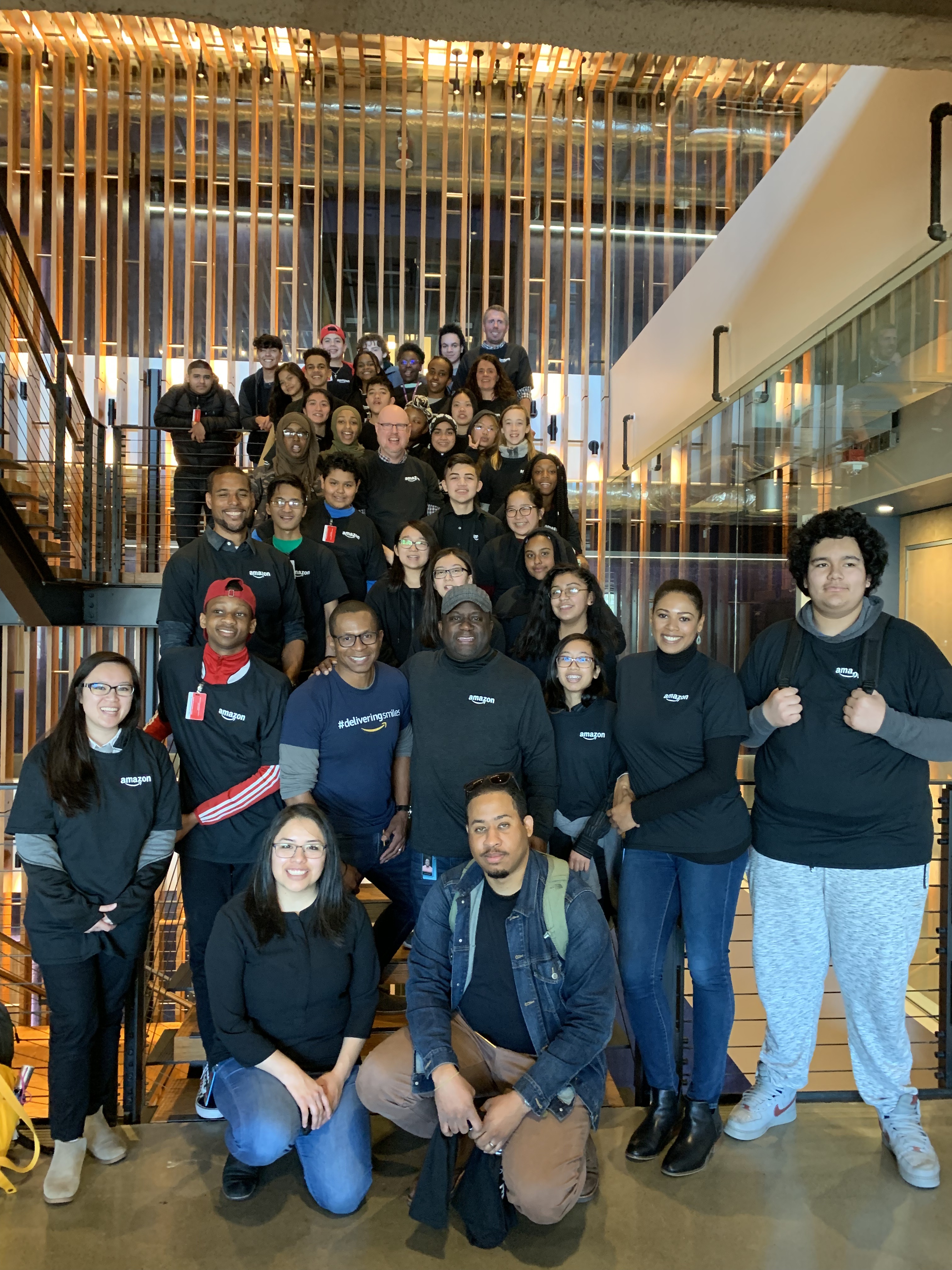 Kent high school students pose with Amazon worksite hosts and employees after ideating the next Alexa app.